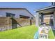 Backyard features a covered patio, artificial turf lawn, and a play area, perfect for relaxation and activities at 9352 E Saturn Ave, Mesa, AZ 85212