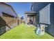 Backyard features a covered patio, artificial turf, and a play area for enjoyment at 9352 E Saturn Ave, Mesa, AZ 85212