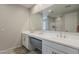 Elegant bathroom featuring dual sinks, quartz countertops, and a large mirror at 9352 E Saturn Ave, Mesa, AZ 85212