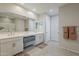Modern bathroom with double vanity, sleek mirrors, and tile flooring at 9352 E Saturn Ave, Mesa, AZ 85212