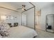 Bright bedroom featuring a stylish four-poster bed, decorative accents, and lots of sunlight at 9352 E Saturn Ave, Mesa, AZ 85212