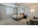 Calm bedroom with neutral tones, four-poster bed, and comfortable furnishings at 9352 E Saturn Ave, Mesa, AZ 85212