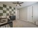 Bedroom featuring a checkerboard accent wall and ample natural light at 9352 E Saturn Ave, Mesa, AZ 85212