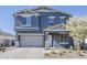 Inviting two-story home featuring a neutral color palette, attached garage, and manicured front yard at 9352 E Saturn Ave, Mesa, AZ 85212