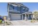 Charming two-story home with a neutral exterior, a brick paved driveway, and manicured landscaping at 9352 E Saturn Ave, Mesa, AZ 85212