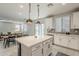 Open-concept kitchen and dining area featuring stainless appliances, island seating, and access to the backyard at 9352 E Saturn Ave, Mesa, AZ 85212