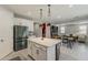 Modern kitchen flowing into the living area featuring stainless appliances, sleek countertops, and pendant lights at 9352 E Saturn Ave, Mesa, AZ 85212
