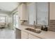 Bright kitchen featuring modern appliances, stainless steel sink and a sliding glass door to the backyard at 9352 E Saturn Ave, Mesa, AZ 85212