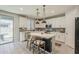 Well-lit kitchen with stainless appliances, island with seating, and a sliding glass door to the backyard at 9352 E Saturn Ave, Mesa, AZ 85212