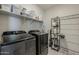 Well-organized laundry room with modern appliances and ample storage at 9352 E Saturn Ave, Mesa, AZ 85212