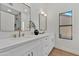 Modern bathroom with double sinks, gold fixtures, decorative mirror, and a view to the shower at 1001 N Nielson St, Gilbert, AZ 85234