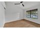 Bright, spacious bedroom with a ceiling fan, laminate flooring, and a large window at 1001 N Nielson St, Gilbert, AZ 85234
