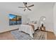Bright bedroom with wood floors, a ceiling fan, and a patterned rug under the bed at 1001 N Nielson St, Gilbert, AZ 85234
