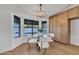 Chic dining space with a glass-top table, contemporary chairs, and abundant natural light at 1001 N Nielson St, Gilbert, AZ 85234
