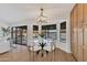 Bright dining area featuring modern furniture, a stylish chandelier, and easy access to the backyard at 1001 N Nielson St, Gilbert, AZ 85234