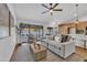 Comfortable living room featuring a plush sofa, a ceiling fan, and an open layout at 1001 N Nielson St, Gilbert, AZ 85234