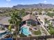 Inviting backyard featuring a private pool, desert landscaping, and a stunning mountain backdrop at 10333 E Gold Nugget Ct, Gold Canyon, AZ 85118