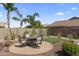 Charming backyard patio with a firepit, desert landscaping, and paver patio, creating a cozy outdoor retreat at 10333 E Gold Nugget Ct, Gold Canyon, AZ 85118
