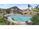 Backyard pool surrounded by desert landscaping, a covered patio, and a charming outdoor dining area at 10333 E Gold Nugget Ct, Gold Canyon, AZ 85118