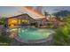 Inviting backyard pool and covered patio, perfect for evening relaxation and outdoor entertainment at sunset at 10333 E Gold Nugget Ct, Gold Canyon, AZ 85118