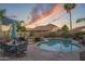 Landscaped backyard with a sparkling pool and an inviting outdoor dining set, perfect for al fresco meals at 10333 E Gold Nugget Ct, Gold Canyon, AZ 85118