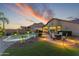Backyard featuring a pool, lounge area, well-manicured lawn, and thoughtful landscape lighting at 10333 E Gold Nugget Ct, Gold Canyon, AZ 85118