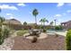 Well-maintained backyard with pool, patio, desert landscaping, and lounge area, perfect for outdoor enjoyment at 10333 E Gold Nugget Ct, Gold Canyon, AZ 85118