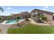 Gorgeous backyard with a pool, lounge area, grassy patch, and tasteful landscaping at 10333 E Gold Nugget Ct, Gold Canyon, AZ 85118