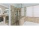 Luxurious bathroom featuring glass-enclosed shower and soaking tub at 10333 E Gold Nugget Ct, Gold Canyon, AZ 85118