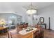 Open-concept dining area with elegant chandelier and seamless flow into the living room at 10333 E Gold Nugget Ct, Gold Canyon, AZ 85118