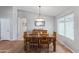 Inviting dining room with a large wood table and contemporary chandelier lighting fixture at 10333 E Gold Nugget Ct, Gold Canyon, AZ 85118