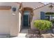 Close up of a charming front entry, showcasing the detailed door, desert landscaping and a secure door at 10333 E Gold Nugget Ct, Gold Canyon, AZ 85118