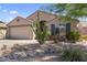 Attractive home showcasing desert landscaping, a two-car garage, and a charming facade at 10333 E Gold Nugget Ct, Gold Canyon, AZ 85118