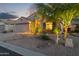 Inviting home at night with warm exterior lighting enhancing the desert landscape and curb appeal at 10333 E Gold Nugget Ct, Gold Canyon, AZ 85118