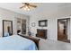 Spacious main bedroom featuring exercise equipment and a sliding door to the backyard at 10333 E Gold Nugget Ct, Gold Canyon, AZ 85118