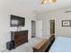 Bedroom with a dresser, TV and entry to the bathroom at 10333 E Gold Nugget Ct, Gold Canyon, AZ 85118