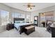 Bright main bedroom with pool view, ceiling fan, and dark wood furniture at 10333 E Gold Nugget Ct, Gold Canyon, AZ 85118