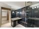 Stylish bathroom features a glass shower, vanity area, modern fixtures, and access to a walk-in closet at 1040 E Osborn Rd # 501, Phoenix, AZ 85014