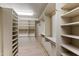 Spacious walk-in closet with built-in shelving and ample storage for shoes and folded clothes at 1040 E Osborn Rd # 501, Phoenix, AZ 85014