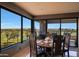Bright dining area featuring a table set for four with panoramic views of the lush green golf course through expansive windows at 1040 E Osborn Rd # 501, Phoenix, AZ 85014