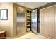 Elegant hallway showcases a stainless steel pantry with storage shelves, enhancing space functionality and aesthetic at 1040 E Osborn Rd # 501, Phoenix, AZ 85014