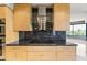 Modern kitchen boasts a granite countertop and stainless steel hood range and stylish wood cabinetry at 1040 E Osborn Rd # 501, Phoenix, AZ 85014