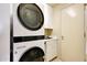 Compact laundry room features a stacked washer and dryer unit and a utility sink at 1040 E Osborn Rd # 501, Phoenix, AZ 85014