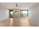 Bright living room features wood floors, ceiling fan, large windows with golf course views, and access to the balcony at 1040 E Osborn Rd # 501, Phoenix, AZ 85014