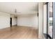 Inviting living area with wood floors, a ceiling fan, and a large window, perfect for relaxing or entertaining at 1040 E Osborn Rd # 501, Phoenix, AZ 85014