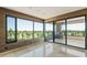 Open living room features tiled floors and expansive windows leading to a balcony with stunning golf course scenery at 1040 E Osborn Rd # 501, Phoenix, AZ 85014