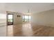 Living room features wood floors, ceiling fan, large windows with golf course views, and access to the balcony at 1040 E Osborn Rd # 501, Phoenix, AZ 85014