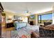 Spacious main bedroom featuring a sitting area, large windows, and a ceiling fan at 1040 E Osborn Rd # 501, Phoenix, AZ 85014