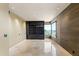 A home office with a custom built-in bookshelf and tile flooring is filled with natural light at 1040 E Osborn Rd # 501, Phoenix, AZ 85014