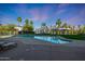 Inviting community pool with multiple seating areas, palm trees, and well-maintained landscaping at 1040 E Osborn Rd # 501, Phoenix, AZ 85014